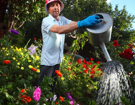 Professional gardener assessing outdoor hazards before beginning maintenance work